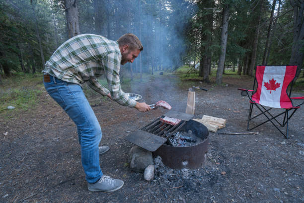 istock Man cooking at campground barbecue in Springtime 811721464