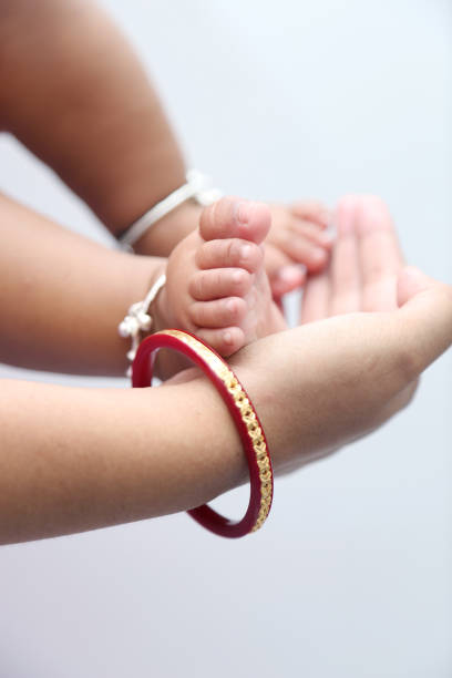 istock Mother holds baby feet in hands. 811724124