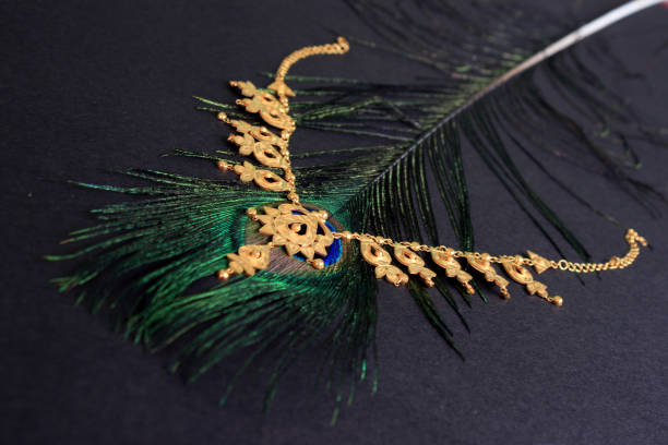istock Gold necklace on peacock feather. Conceptual wedding photography. 811728310