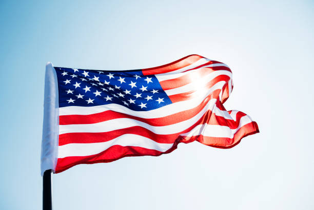 istock American flag waving against blue sky 811728382