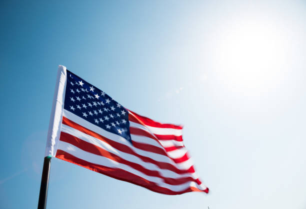 istock American flag waving against blue sky 811728402