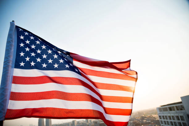 istock American flag waving in sunset 811730814