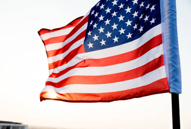 istock American flag waving in sunset 811730854