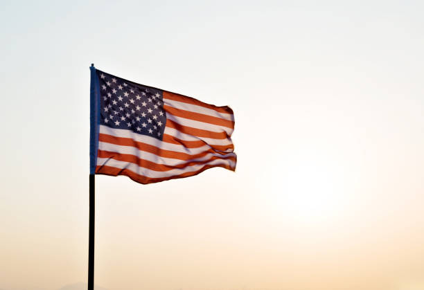 istock American flag waving in sunset 811730876