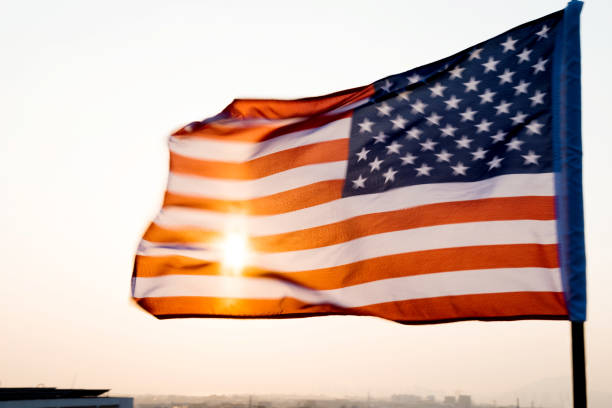 istock American flag waving in sunset 811730878