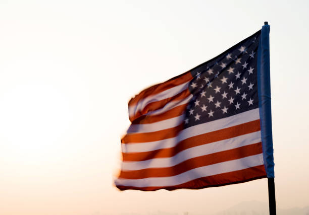 istock American flag waving in sunset 811730882