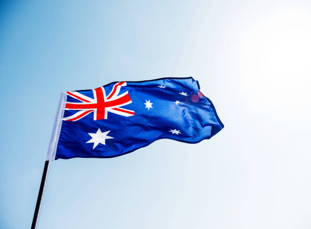 istock Waving Australia flag against blue sky 811730908