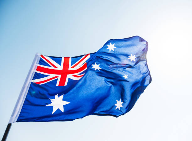 Waving Australia flag against blue sky
