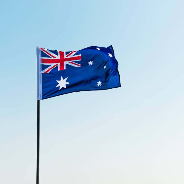 istock Waving Australia flag against blue sky 811730938