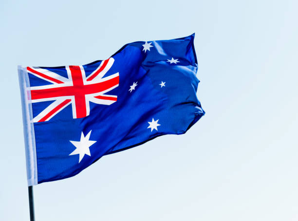 istock Waving Australia flag against blue sky 811730942