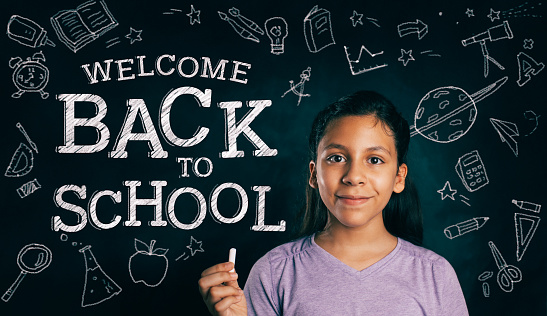 Smiling young girl with a back to school message.