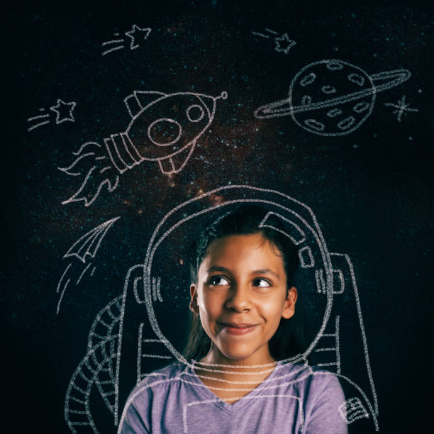 young space explorer aspirations Young girl smiling, imagining she will be an astronaut. board eraser photos stock pictures, royalty-free photos & images