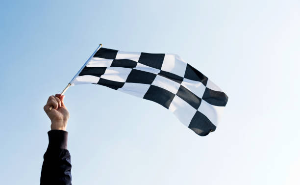 istock Man hand holding checkered flag in the wind 811755214