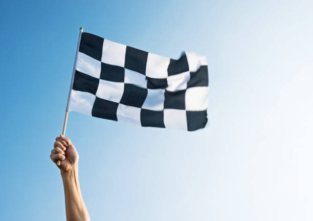 istock Man hand holding checkered flag in the wind 811755328