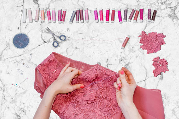 istock A seamstress finishing up decorating a dress 811757736