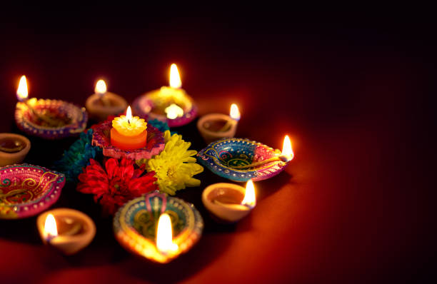 istock Colorful clay diya lamps lit during diwali celebration 811762516