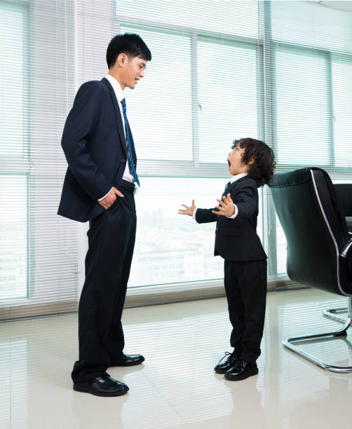 istock Father and son talking in the office 811765314
