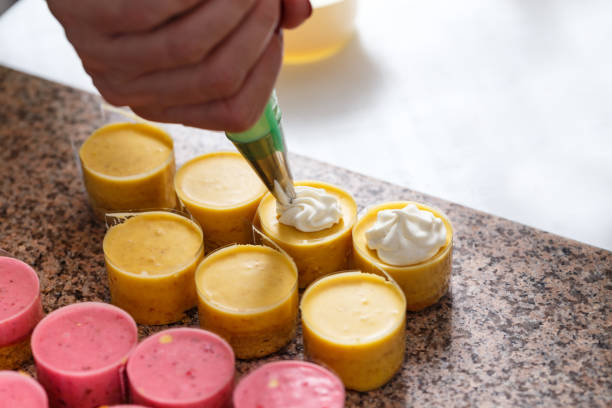 istock Woman hand decorating mini cakes 811782970