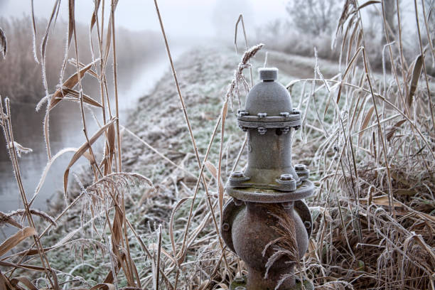 Dewatering ditch in Havelland, Brandenburg. In the foreground is a pressure valve with which the water level can be regulated.