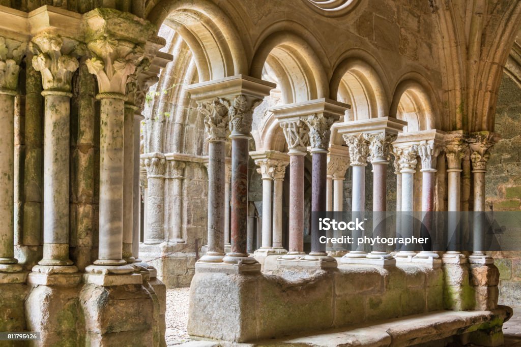 Cloister of the Abbaye de Fontfroide Medieval columns and arches in warm light Abbey - Monastery Stock Photo