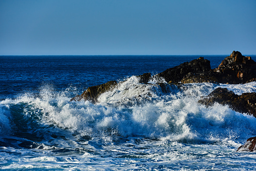 sea side view in Tenerife, waves splashing at Benijo Beach in summer day.