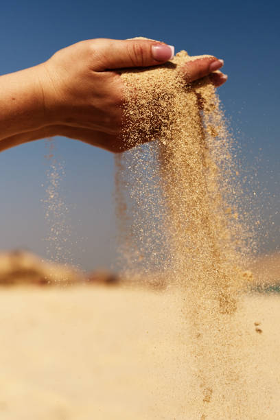 time is passing in the wind vertical shot of unrecognizable woman hand with sand in the wind. sifting stock pictures, royalty-free photos & images