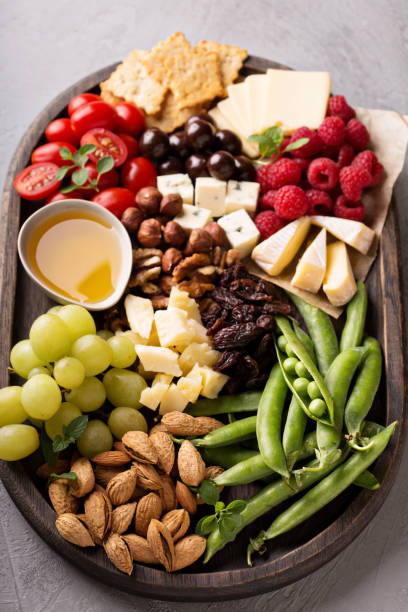 istock Cheese plate with fresh vegetables and fruits 811808196