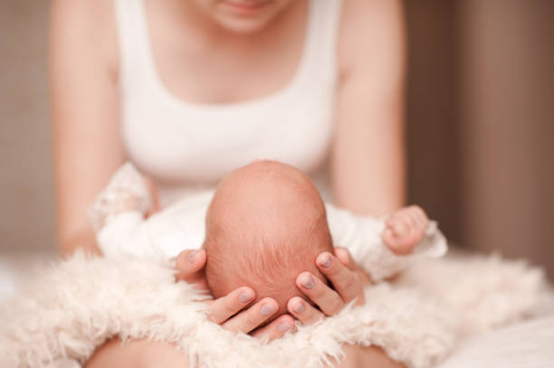 istock Woman holding baby 811813530
