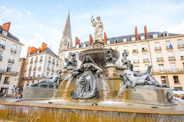 Nantes city in France View on the Royal square with fountain and church tower in Nantes city in France nantes stock pictures, royalty-free photos & images
