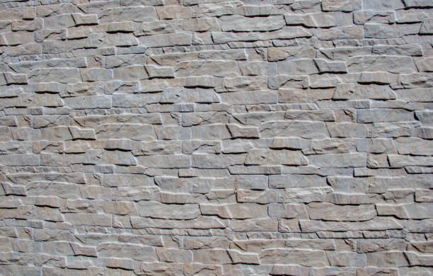 istock Wall made of the same type of stones 811833376