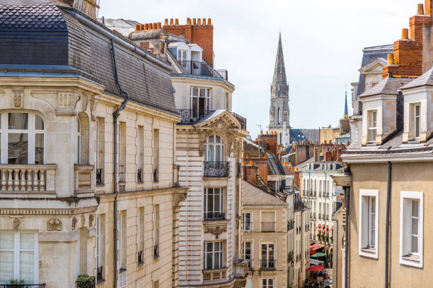 Nantes city in France Street view on the beautiful residential buildings andchurch tower in Nantes city during the sunny day in France nantes stock pictures, royalty-free photos & images