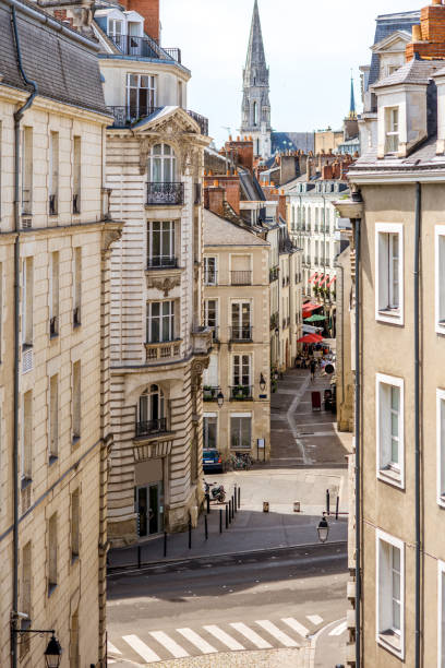 Nantes city in France Street view on the beautiful residential buildings andchurch tower in Nantes city during the sunny day in France nantes photos stock pictures, royalty-free photos & images