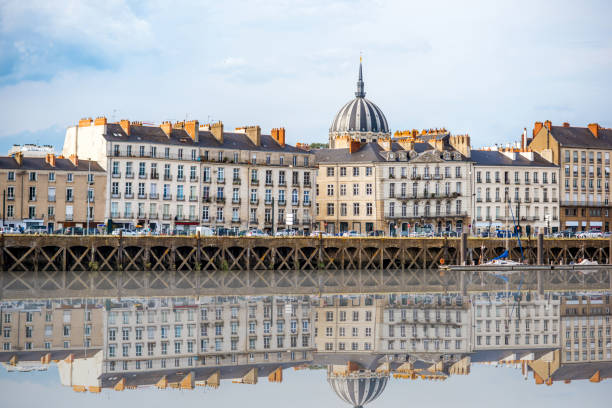 Nantes city in France Beautiful riverside view with old buildings and Notre Dame cathedral in Nantes city in France nantes stock pictures, royalty-free photos & images