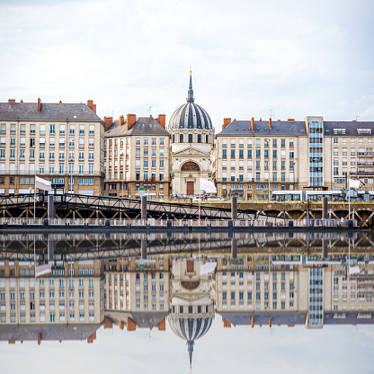 Beautiful riverside view with old buildings and Notre Dame cathedral in Nantes city in France