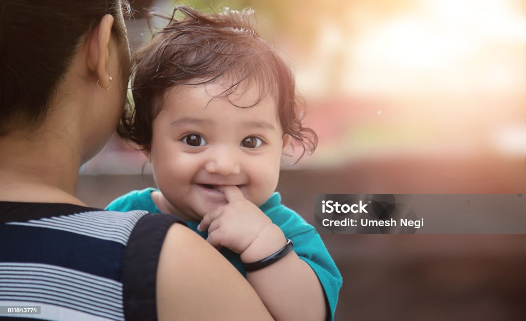 Indian Mother and Daughter Young Indian Mother with her Loving Baby Girl Daughter Baby - Human Age Stock Photo