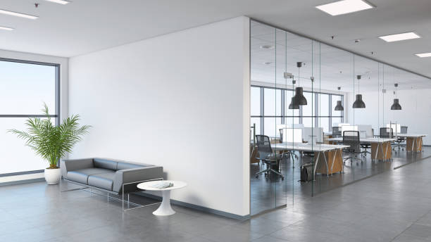 Modern business office space with lobby Interior view of a modern office, business template. Left side of the picture is large sofa with a plant and coffee table. Blank wall for copy space. On the right, many office desks with pendant lights above. large windows. gray floor tiles, white walls. Render office partition stock pictures, royalty-free photos & images