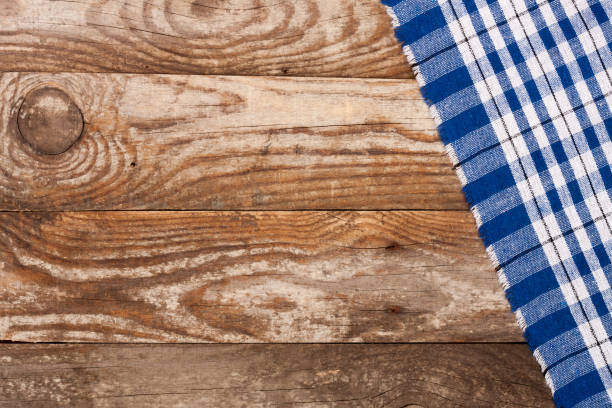 istock blue checkered tablecloth on the old wooden table with copy space for your text. Top view 811846626