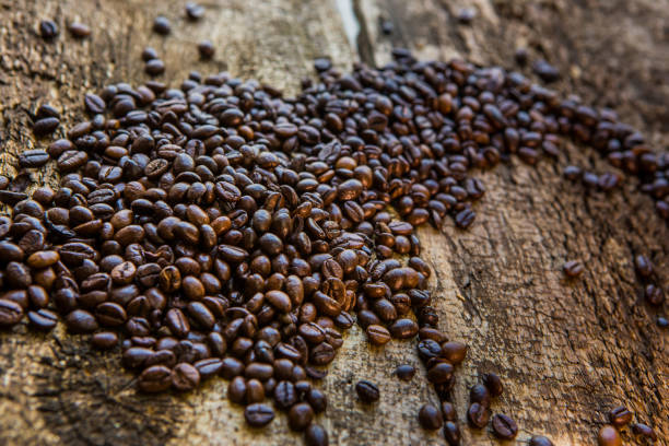 istock Coffee beans on wood texture background 811849654