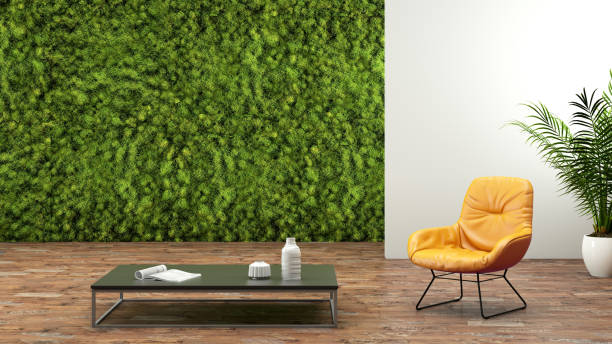 Modern interior with armchair and a green wall Modern interior, environmental theme, orange armchair, coffee table, wooden floor, green plant garden wall in the background. letterbox composition. designer copy space template wide screen photos stock pictures, royalty-free photos & images