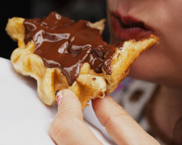 istock Girl eating waffle with chocolate. 811864498