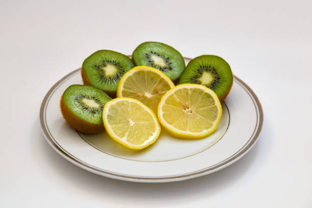 istock Kiwi and lemon on a white plate 811870008