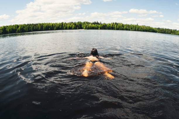 Girl swiming in the lake. stock photo