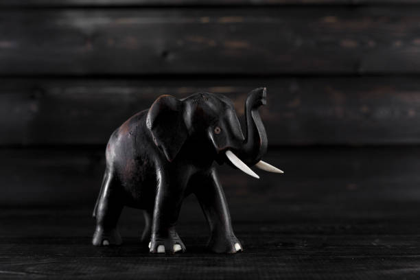 istock Wodden elephant statue on wooden background 811878036