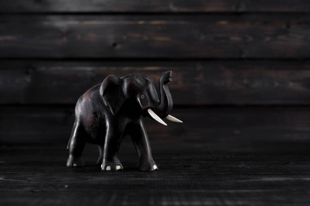 istock Wodden elephant statue on wooden background 811878064