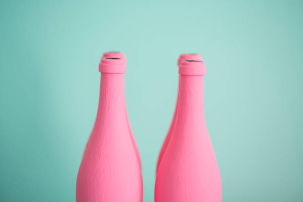 istock Pink bottles against pastel turquoise background 811880374
