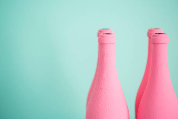istock Pink bottles against pastel turquoise background 811880380