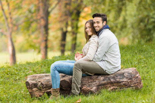 istock Young couple sitting in forest 811880470