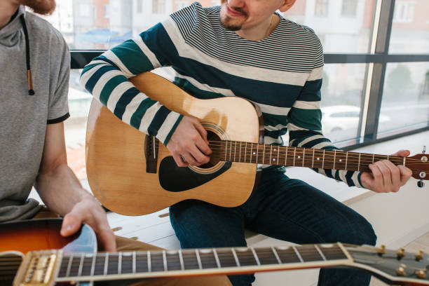istock Learning to play the guitar. Music education and extracurricular lessons. 811888260