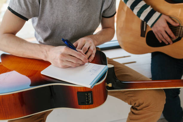 istock Learning to play the guitar. Music education and extracurricular lessons. 811888394