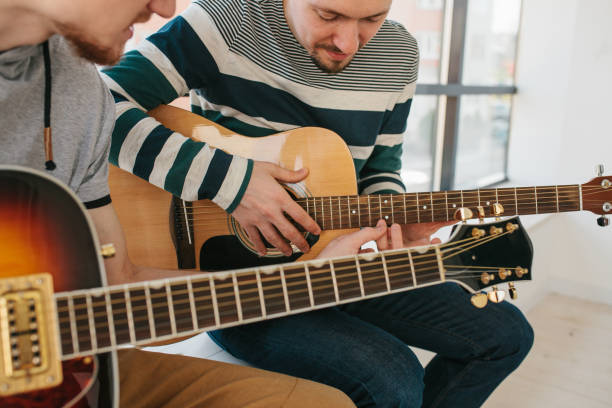 Learning to play the guitar. Music education and extracurricular lessons.
